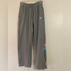 Adidas sweatpants with writing on side, size Medium